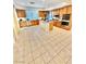 Spacious kitchen with stainless appliances, wood cabinets, island, and tile flooring at 10680 Sapphire Vista Ave, Las Vegas, NV 89144