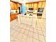 Kitchen with wood cabinets, granite countertops, a center island, and tile flooring at 10680 Sapphire Vista Ave, Las Vegas, NV 89144