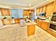 Spacious kitchen featuring an island, light cabinets, and stainless steel appliances at 10680 Sapphire Vista Ave, Las Vegas, NV 89144