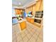 Kitchen with island, wood cabinets, stainless steel appliances and tile flooring at 10680 Sapphire Vista Ave, Las Vegas, NV 89144