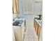 Bright laundry room with front-load washer and dryer, upper cabinets, and a sink with cabinet storage underneath at 10680 Sapphire Vista Ave, Las Vegas, NV 89144