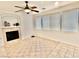 Living room with fireplace, tile floors, and windows providing natural light at 10680 Sapphire Vista Ave, Las Vegas, NV 89144
