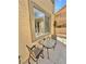 Outdoor patio with seating area beside the house and backyard wall at 10680 Sapphire Vista Ave, Las Vegas, NV 89144
