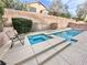 Backyard pool featuring a spa, lounging chairs, and privacy wall at 10680 Sapphire Vista Ave, Las Vegas, NV 89144