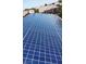 Close up of solar panels on roof with surrounding homes in background showing eco friendly neighborhood at 10680 Sapphire Vista Ave, Las Vegas, NV 89144