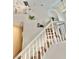 A view of the home's carpeted staircase, with white banisters, leading to the upper level at 10680 Sapphire Vista Ave, Las Vegas, NV 89144