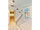 Bright staircase with white railings leads to an upper level overlooking tile and carpet flooring at 10680 Sapphire Vista Ave, Las Vegas, NV 89144