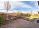 Backyard featuring a brick-paver patio, lush lawn, and a decorative retaining wall with landscaping at 16 Cresta Villa Ct, Henderson, NV 89011