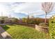 Manicured backyard featuring a retaining wall, lush lawn, mature landscaping, and ample space for relaxation at 16 Cresta Villa Ct, Henderson, NV 89011