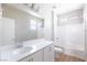 Bright bathroom featuring a white vanity with modern fixtures and a shower-tub combination at 16 Cresta Villa Ct, Henderson, NV 89011