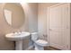 Clean bathroom with a pedestal sink, toilet, and neutral-toned walls at 16 Cresta Villa Ct, Henderson, NV 89011