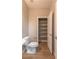 Bathroom with open linen storage, toilet, and neutral-toned walls at 16 Cresta Villa Ct, Henderson, NV 89011