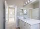 Bathroom with white cabinets, and entry to room and view of hallway beyond at 16 Cresta Villa Ct, Henderson, NV 89011