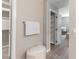 Bright bathroom featuring a walk-in closet, shelving, towel rack, and plush ottoman at 16 Cresta Villa Ct, Henderson, NV 89011