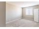 An empty carpeted bedroom is brightly lit by a window with white trim at 16 Cresta Villa Ct, Henderson, NV 89011