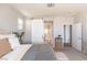 Bedroom featuring ensuite bath, barn door, comfortable bedding and modern furniture at 16 Cresta Villa Ct, Henderson, NV 89011