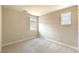 Empty carpeted bedroom brightly lit by two windows in a neutral color palette at 16 Cresta Villa Ct, Henderson, NV 89011
