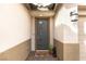 Inviting entryway with a modern gray door, a 'Welcome' mat, and stylish wall sconces at 16 Cresta Villa Ct, Henderson, NV 89011