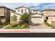 Charming two-story home with a two-car garage, lush landscaping, and a welcoming front yard at 16 Cresta Villa Ct, Henderson, NV 89011