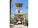 Charming stone tower with arched entrance to a pedestrian bridge, nestled among lush greenery at 16 Cresta Villa Ct, Henderson, NV 89011