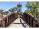 Picturesque footbridge with stone tower and lush greenery, creating a peaceful walkway at 16 Cresta Villa Ct, Henderson, NV 89011