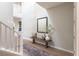 Bright foyer featuring a decorative bench, mirror, and elegant staircase at 16 Cresta Villa Ct, Henderson, NV 89011