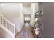 Open foyer with staircase, modern decor, and a glimpse of the living area at 16 Cresta Villa Ct, Henderson, NV 89011