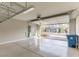 View of the garage with epoxy floors and the opened garage door shows the home's front exterior at 16 Cresta Villa Ct, Henderson, NV 89011
