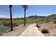 A scenic paved golf cart path winds through the green fairways lined with trees and mountains in the background at 16 Cresta Villa Ct, Henderson, NV 89011