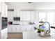 Gourmet kitchen with stainless steel appliances, center island, modern backsplash, and quartz countertops at 16 Cresta Villa Ct, Henderson, NV 89011