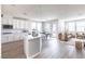 Bright and open kitchen with white cabinets, an island, and a view of the dining area and living space at 16 Cresta Villa Ct, Henderson, NV 89011