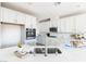 Bright kitchen with stainless appliances, modern fixtures, quartz countertops and large single bowl sink at 16 Cresta Villa Ct, Henderson, NV 89011