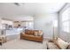 Open-concept living room featuring a cozy leather sofa and seamless connection to the modern kitchen at 16 Cresta Villa Ct, Henderson, NV 89011