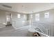 Bright and airy loft area featuring multiple windows, neutral paint, and plush carpeting at 16 Cresta Villa Ct, Henderson, NV 89011