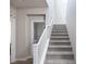 Carpeted staircase featuring white railings leads to the upper level of the home at 16 Cresta Villa Ct, Henderson, NV 89011