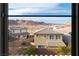 Window view overlooking rooftops and mountain range against a clear blue sky in the distance at 16 Cresta Villa Ct, Henderson, NV 89011
