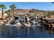 Scenic water feature with cascading waterfalls and lush landscaping, creating a tranquil atmosphere at 16 Cresta Villa Ct, Henderson, NV 89011