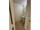 Powder room with a pedestal sink, tile flooring, and a decorative wall mirror at 161 Lenape Heights Ave, Las Vegas, NV 89148
