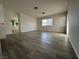 Bright main bedroom with wood-look flooring, natural light, and an ensuite bathroom at 161 Lenape Heights Ave, Las Vegas, NV 89148