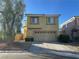 Two-story home featuring tan stucco, red tile roof, two-car garage, and desert landscaping at 161 Lenape Heights Ave, Las Vegas, NV 89148