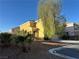 Two-story home featuring tan stucco, red tile roof, desert landscaping, and a front yard tree at 161 Lenape Heights Ave, Las Vegas, NV 89148