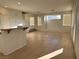 Open-concept kitchen featuring white cabinets, an island, and tile flooring at 161 Lenape Heights Ave, Las Vegas, NV 89148