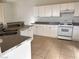 Kitchen featuring white cabinets, gray countertops, tile flooring at 161 Lenape Heights Ave, Las Vegas, NV 89148