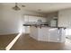 Open-concept kitchen featuring white cabinets, an island, and tile flooring at 161 Lenape Heights Ave, Las Vegas, NV 89148