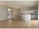 Open-concept kitchen featuring white cabinets, an island, and tile flooring at 161 Lenape Heights Ave, Las Vegas, NV 89148