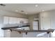 Bright kitchen with white cabinets, modern appliances, breakfast bar at 161 Lenape Heights Ave, Las Vegas, NV 89148