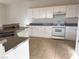 Kitchen featuring white cabinets, gray countertops, tile flooring at 161 Lenape Heights Ave, Las Vegas, NV 89148