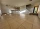 Open-concept living room with tile flooring, staircase, and a kitchen in the background at 161 Lenape Heights Ave, Las Vegas, NV 89148