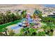 A colorful water park featuring a variety of slides and water features surrounded by palm trees in a community at 161 Lenape Heights Ave, Las Vegas, NV 89148