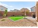 Backyard with low maintenance gravel and pavers, with a small patch of artificial turf at 1783 Matteo Cove Pl, North Las Vegas, NV 89084